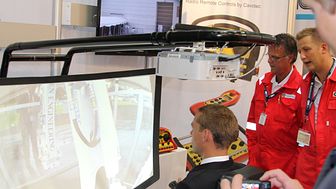 Norway's Minister of Petroleum and Energy, Ola Borten Moe, operates an excavator using a Cavotec radio remote control video link system at ONS 2012