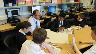 Teacher Mr Smith with S3 pupils at Springburn Academy with the Money Wise textbooks