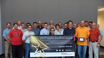 The Cavotec USA Inc. team with their Raytheon Supplier Excellence award banner 