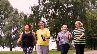 Four women enjoy a walk in a local park