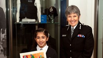 [The Commissioner with this year’s schools poster competition winner, eight-year-old Emmanuelle Barakat]