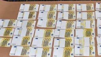 [Image of recovered counterfeit cash]