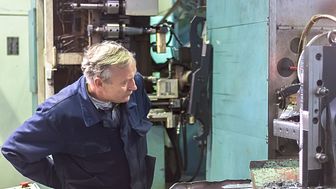A senior plant production operator inspects a milling machine. Could partial-retirement help him to remain in the workforce for longer? Image: Sergei Butorin / Shutterstock.com
