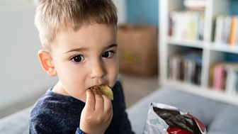 Child eating unhealthy snacks.jpg