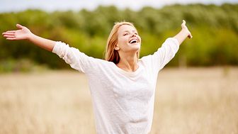 image-of-happy-woman-with-outstretched-arms-standing-in-field-SBI-300739711.jpg