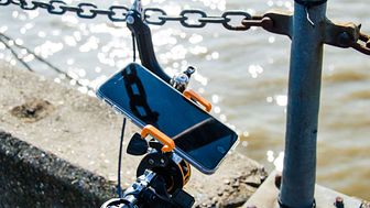 iPhone attached to bicycle handlebars by the Thames
