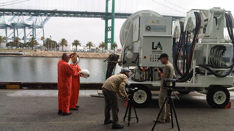 Mårten and Oskar discuss filming tactics beside a Cavotec AMP Mobile unit at the Port of LA #Cavotecfilm #shorepower