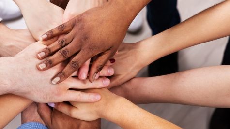 53384144-diverse-people-stacking-hand-together-2