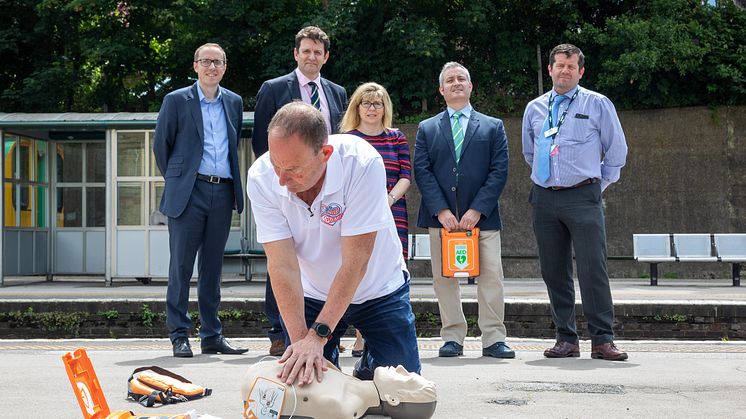 Resuscitation Trainer Steve Morris demos heart restarter to (l to r) Southern's Head of Safety Mark Whitley, Sussex Heart Charity (SHC) Trustees Chair Mike Lewis, Maria Caulfield MP,  SHC Vice-Chair Jason Palmer, Lewes Station Manager Andy Gardner