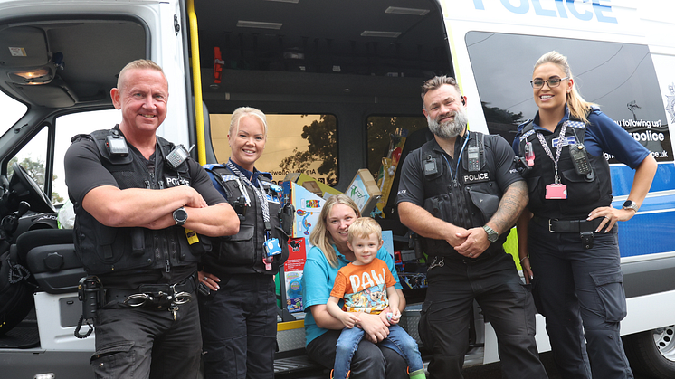 PC Pete Gardiner, PCSO Sarah Walters, PC Colin Bland, and PCSO Stevie Willetts with Harrison and mum Claire