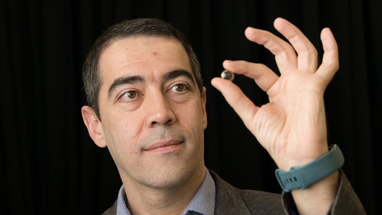 Professor Hamdi Torun, pictured holding the contact lens, developed to detect early signs of glaucoma.