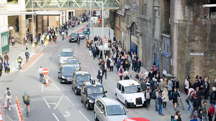 A street near London Bridge full of vehicles and pedestrians