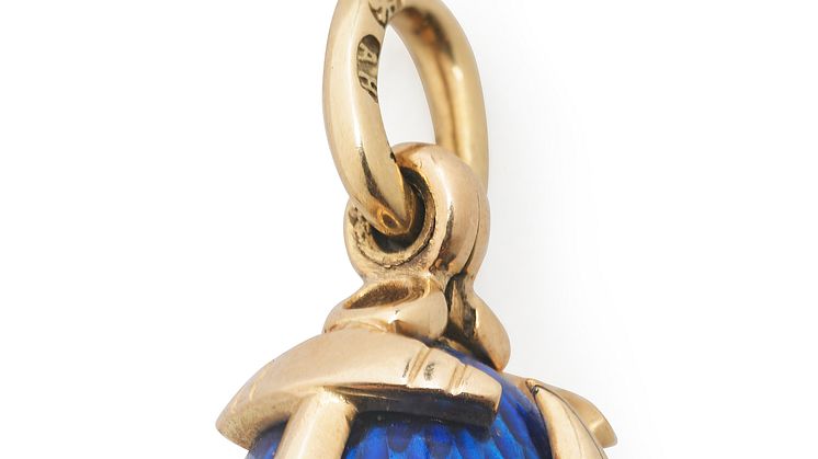 August Holmström: A Russian Easter egg pendant with blue translucent enamel on guilloched ground, set with anchor formed 14k gold cagework.