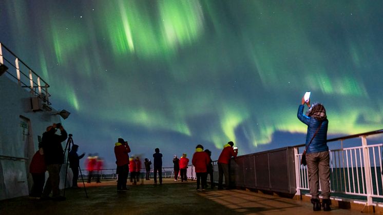 Guests onboard Hurtigruten's Original Coastal Express enjoying the Northern Lights. Photo: Tommy Simonsen
