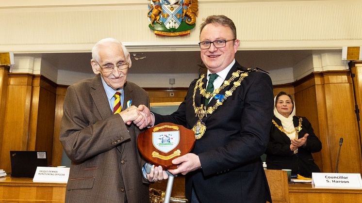 Colonel Eric Davidson is presented with his commemorative shield by the Mayor of Bury, Cllr Tim Pickstone.