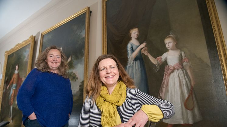 Emma Thomas, General Manager of Seaton Delaval Hall (left); and Nicky Grimaldi, Assistant Professor of Art Conservation at Northumbria University, pictured in front of the portrait of the Delaval sisters.