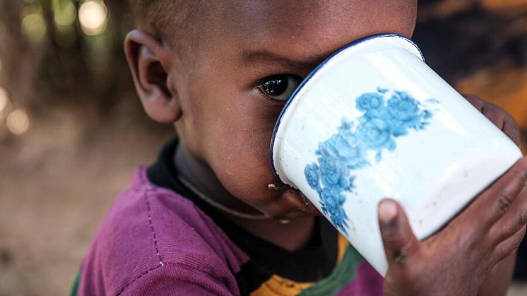  Abdi drinks a cup of milk ,five months after recovering from SAM, at their home, Ethiopia