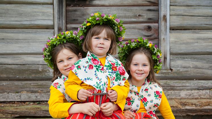 Three girls in folk costume in Leksand, Dalarna. Photo: Kola Productions / Visit Dalarna
