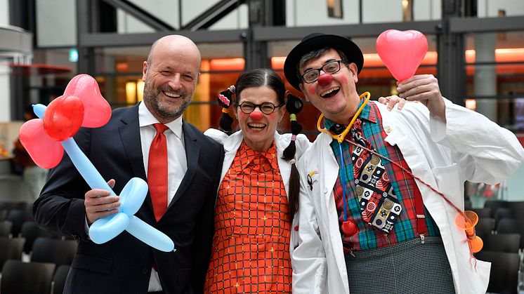 Ralf Fleischer, Vorstandsvorsitzender der Stadtsparkasse München mit zwei KlinikClowns.