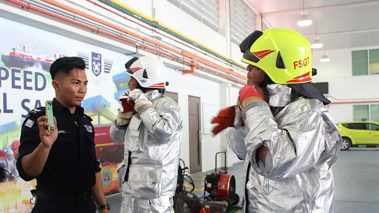 Students learning how to suit up quickly for fire-fighting training