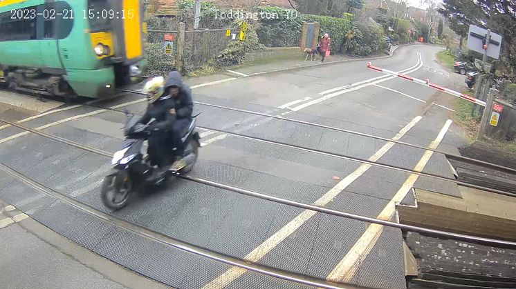 Moped riders narrowly miss being struck by a train in West Sussex