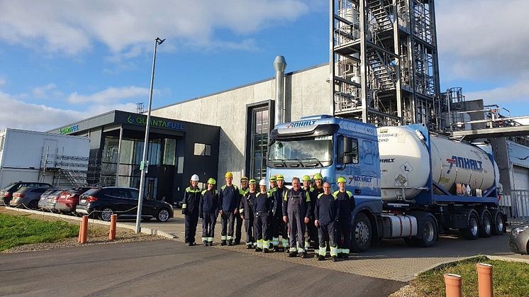 Quantafuel team members at Skive in front of a shipment ready to go to BASF