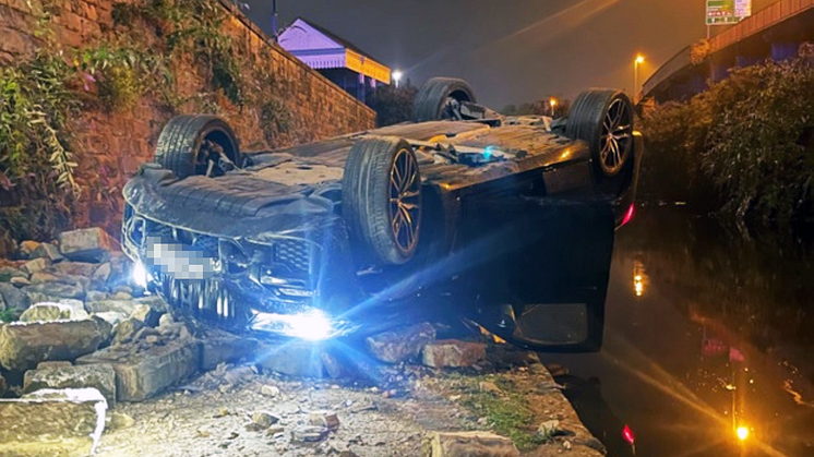 A BMW landed on its roof after crashing onto a canal path