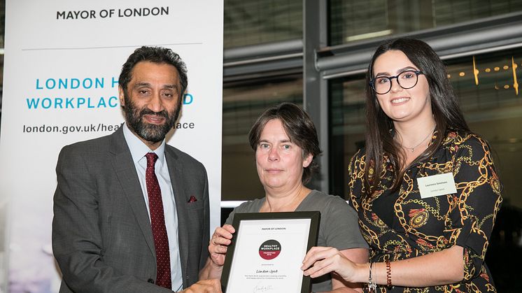 London Assembly member Dr Onkar Sahota presents the award to London Sport's Susan Hutton and Laureece Simmons
