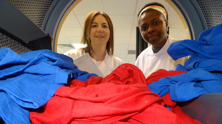 Dr Kelly Sheridan and PhD student Chimdia Kechi Okafor with a test load in a tumble dryer