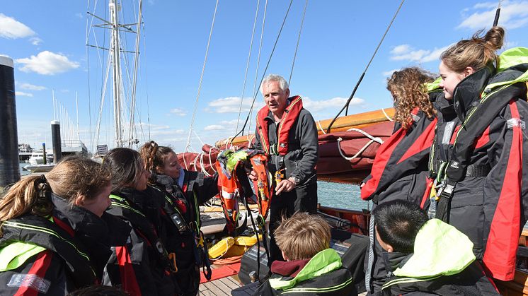 Hi-res image - Ocean Signal - Head of Sailing at Dauntsey’s Toby Marris briefs the Jolie Brise crew about the Ocean Signal rescueME MOB1