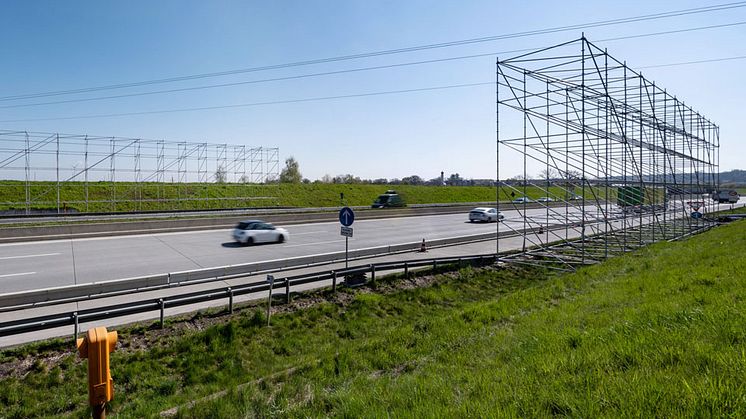 Neben der Autobahn bei Sulzemoos baut die Bayernwerk Netz Gerüste auf. Ein Netz über der A8 soll während der anstehenden Sanierung der Hochspannungsleitung die Autofahrer schützen.