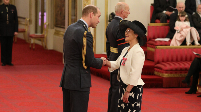Professor Jane Core recieving her MBE from Duke of Cambridge