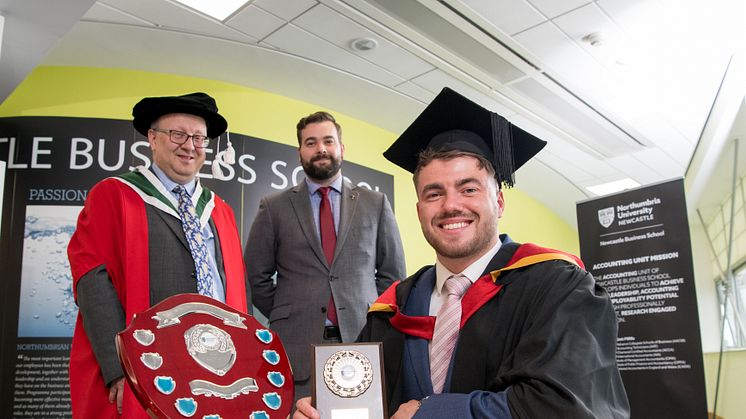 Business graduate Joel Tate with Richard Talbot-Jones from NIBE and Professor Philip Shrives from Northumbria