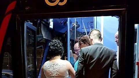 Newlyweds Kayleigh and Colin Thompson jump on-board the bus for their journey home