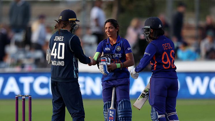 Amy Jones with Harmanpreet Kaur and Harleen Deol after India's win. Photo: Getty Images