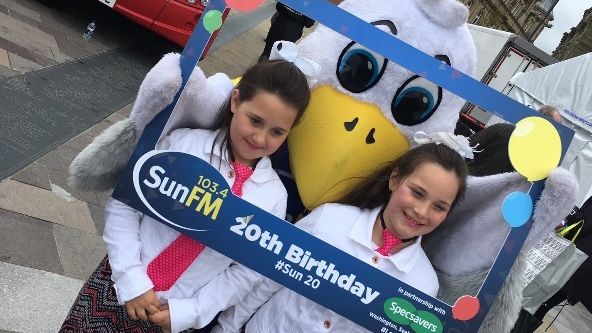 Local youngsters pose with Sunny the Seagull and the Go North East Sun FM bus at the station’s birthday bash 