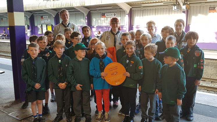 Members of 1st Bournville Scout Group with their Cross City Heroes plaque at Bournville station