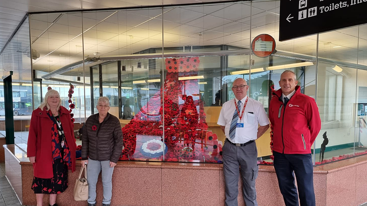 (L-R) Two of Go North East's customers who knitted poppies for the display, with bus station supervisor John Gordon and driver Neil Kennedy