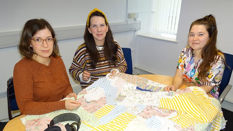 Dr Angelika Strohmayer working on the quilt with colleagues from Swansea and Aberystwth Universities