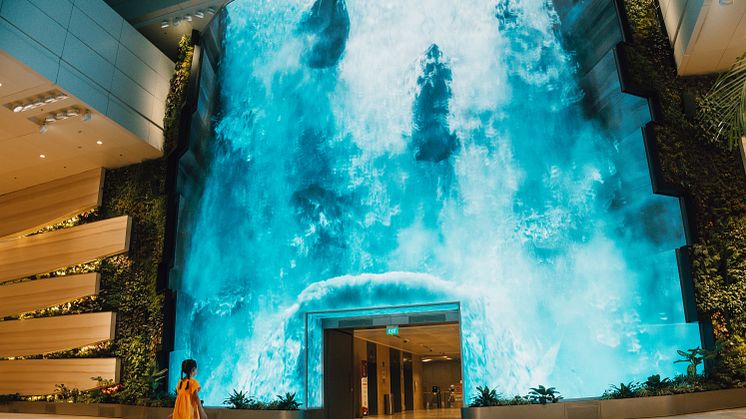 Be transported to a captivating realm as a grand digital waterfall descends at T2's departure hall
