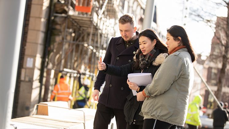 Alex Slack, Bigg Market Project Manager at NE1, pictured with two of the Northumbria students involved in the project,  Chang Shi Qian and Franz Pancho