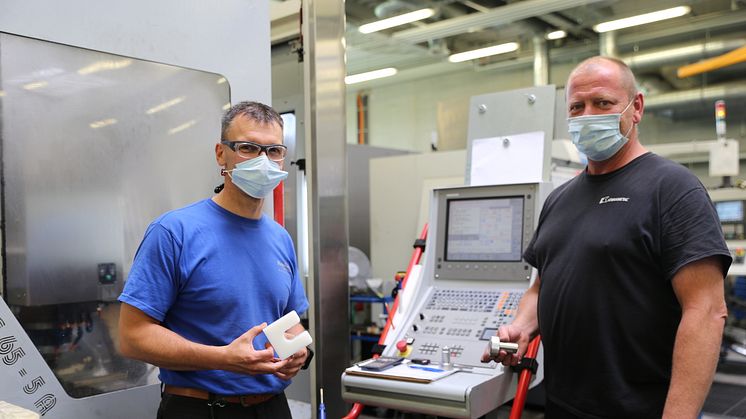 CNC-Fräser Martin Dörrbecker (links) und CNC-Dreher Jens Kühn präsentieren die in der Hephata-Werkstatt für Menschen mit Behinderungen in Schwalmstadt-Ziegenhain gefertigten Teile.