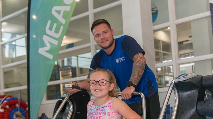 Avah McGinty, pictured with lifeguard Jason, trying out the Poolpod at Seven Towers Leisure Centre.