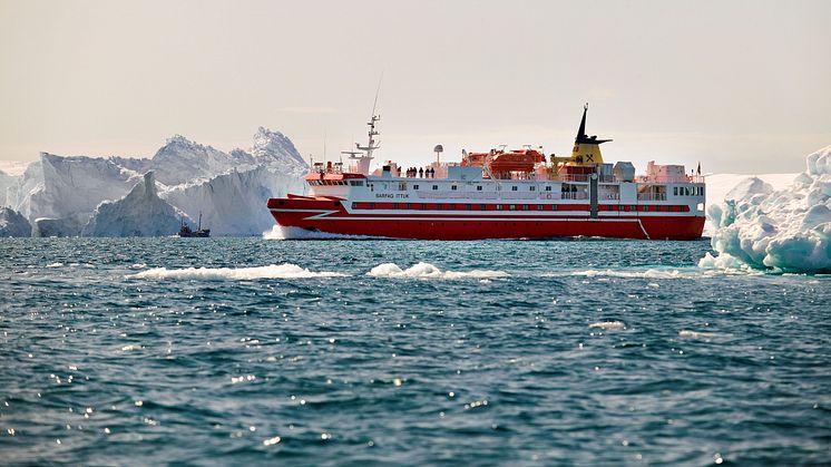 Fishing trawler and coastal ferry Sarfaq Ittuk among icebergs in Ilulissat Icefjord in Greenland