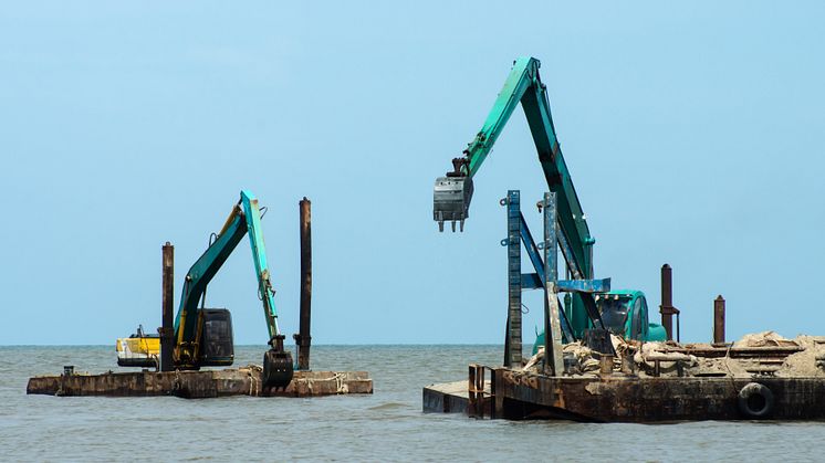 22709395-machines-are-dredging-sand-in-the-sea.jpg