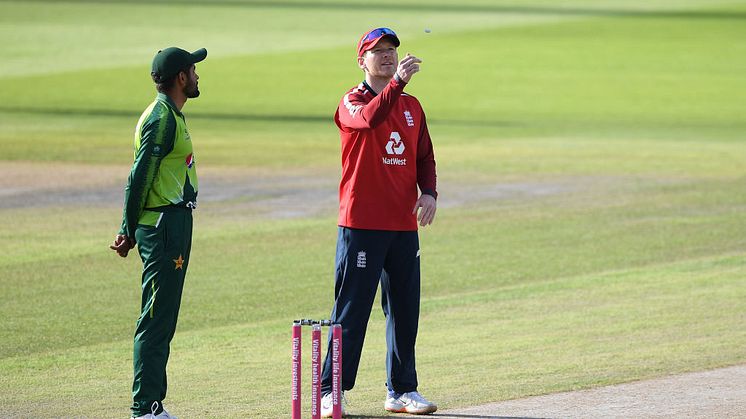 England captain Eoin Morgan performs the toss watched on by Pakistan captain Babar Azam prior to the 3rd Vitality International Twenty20 match between England and Pakistan at Emirates Old Trafford on September 01, 2020 in Manchester, England. (Photo 