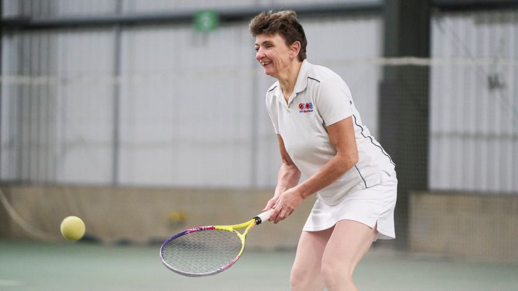 A visually impaired tennis player enjoys a game
