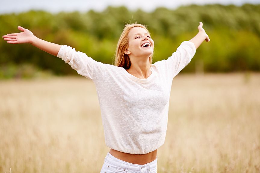 image-of-happy-woman-with-outstretched-arms-standing-in-field-SBI-300739711.jpg