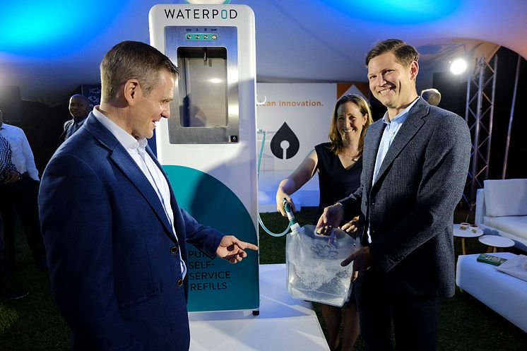 Filling a reuseable water pouch from the Waterpod are Blue CEO Anders Jacobson (right) and James Steere (left), I-Drop Water co-founder and Director Bluewater operations in Africa.