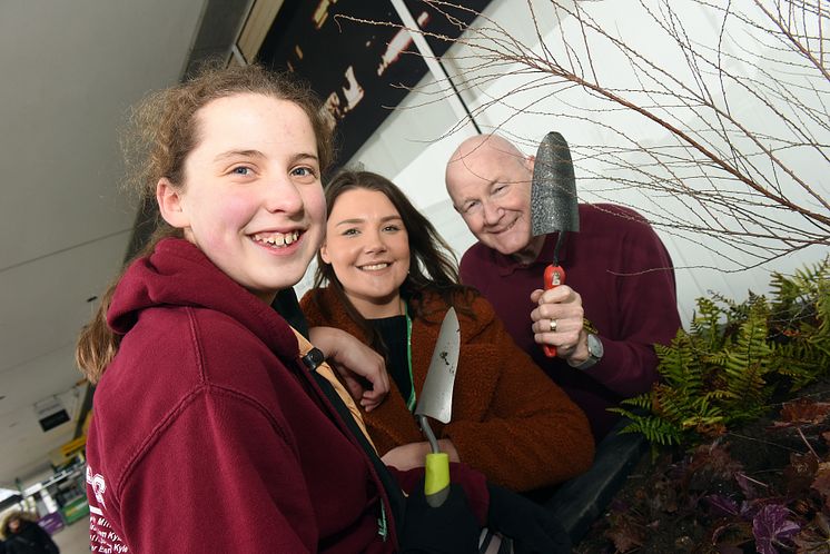 Great Linford Scouts, railway staff and volunteers fill planters at Milton Keynes station